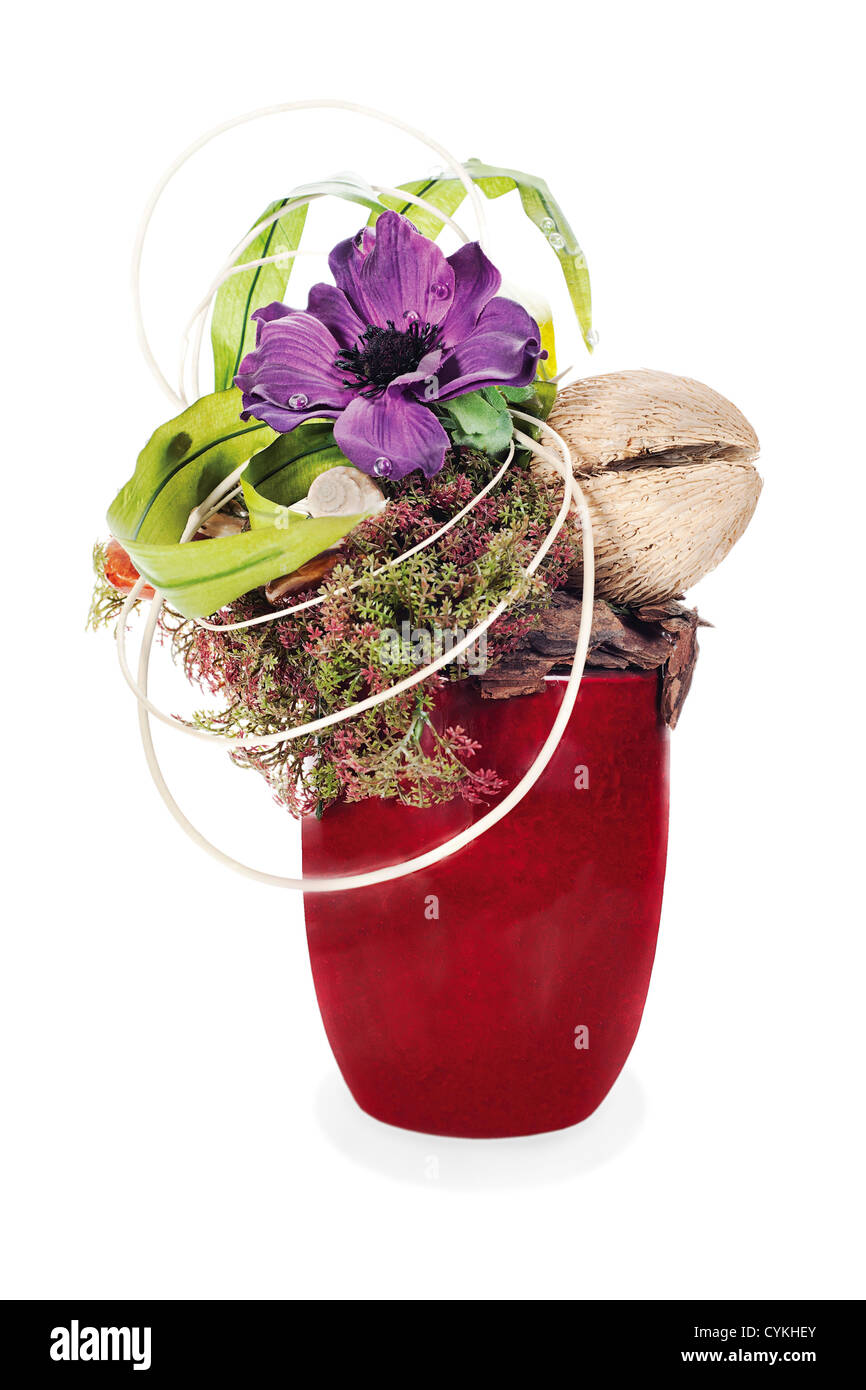 abstract composition from coconut, flower, rocks and vines arrangement centerpiece in vase