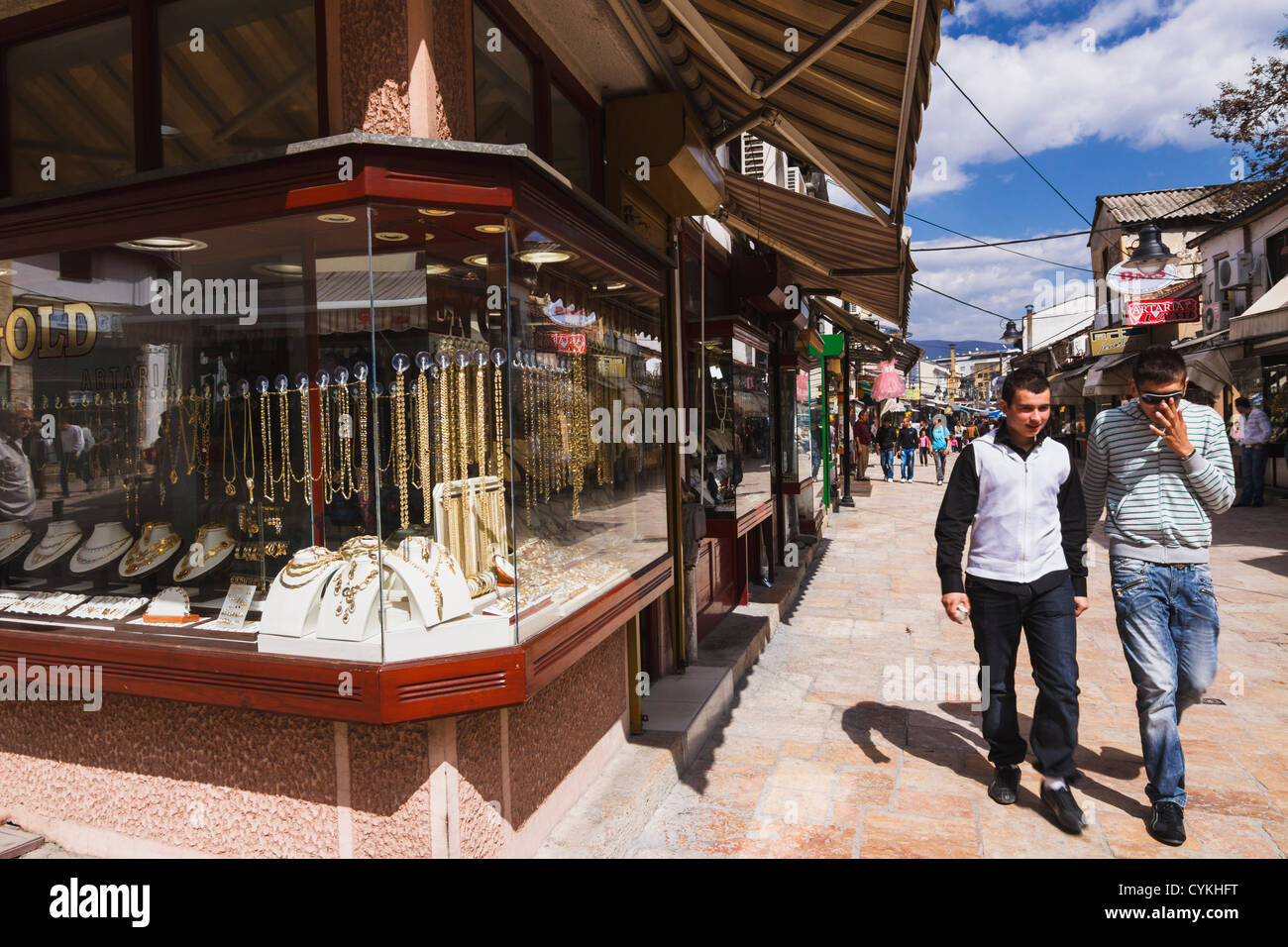 Two young men walking by a gold jewellery in Carsija district-Old Bazaar. Skopje, Macedonia Stock Photo