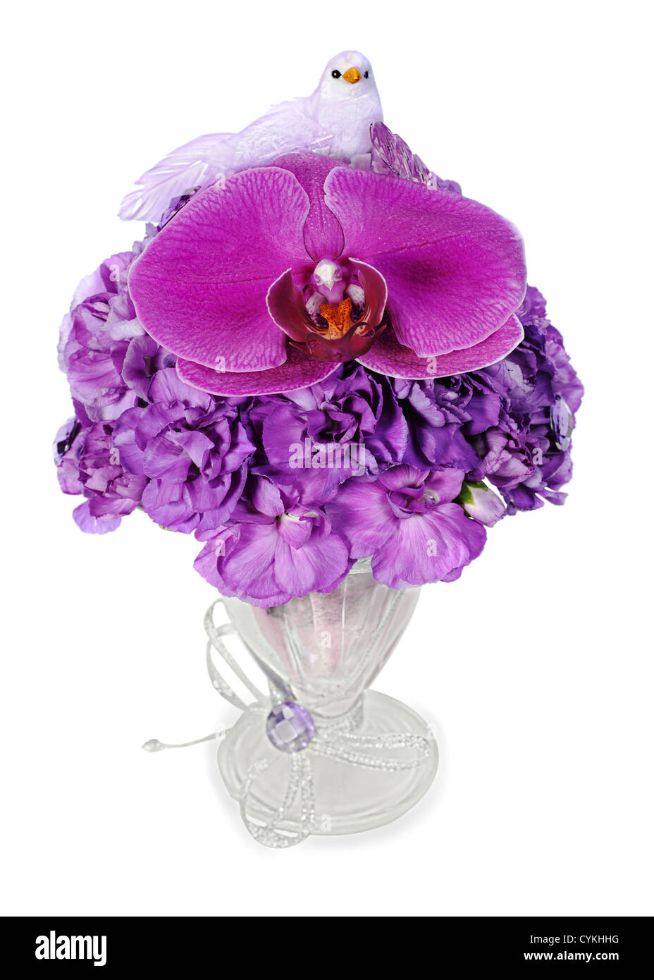 colorful arrangement of orchids, hydrangeas and blue birds held vertically in a glass vase, isolated on white background Stock Photo
