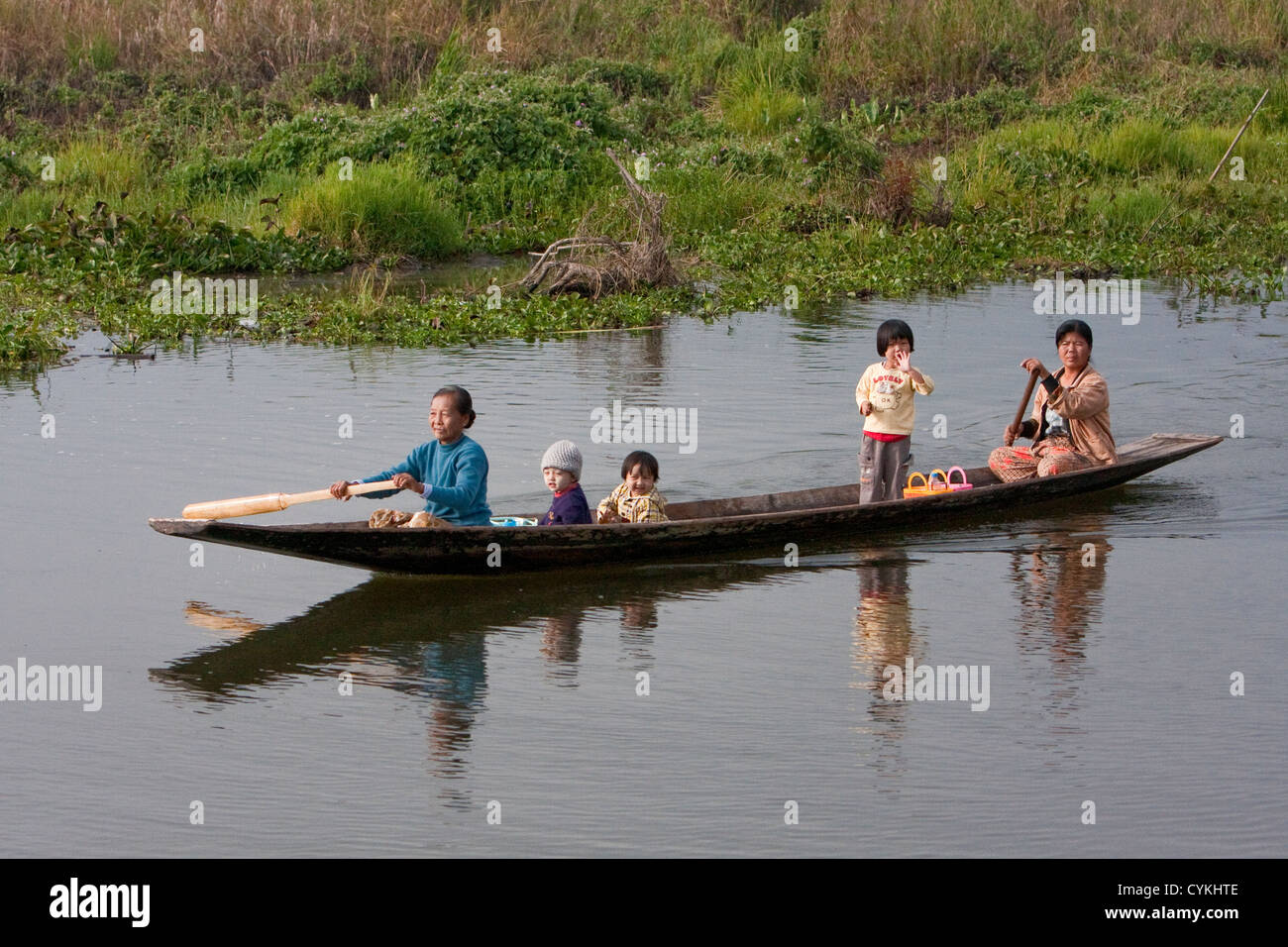 Myanmar, Burma. Mother and Children in Canoe, Paddling, Inle Lake, Shan State. Stock Photo