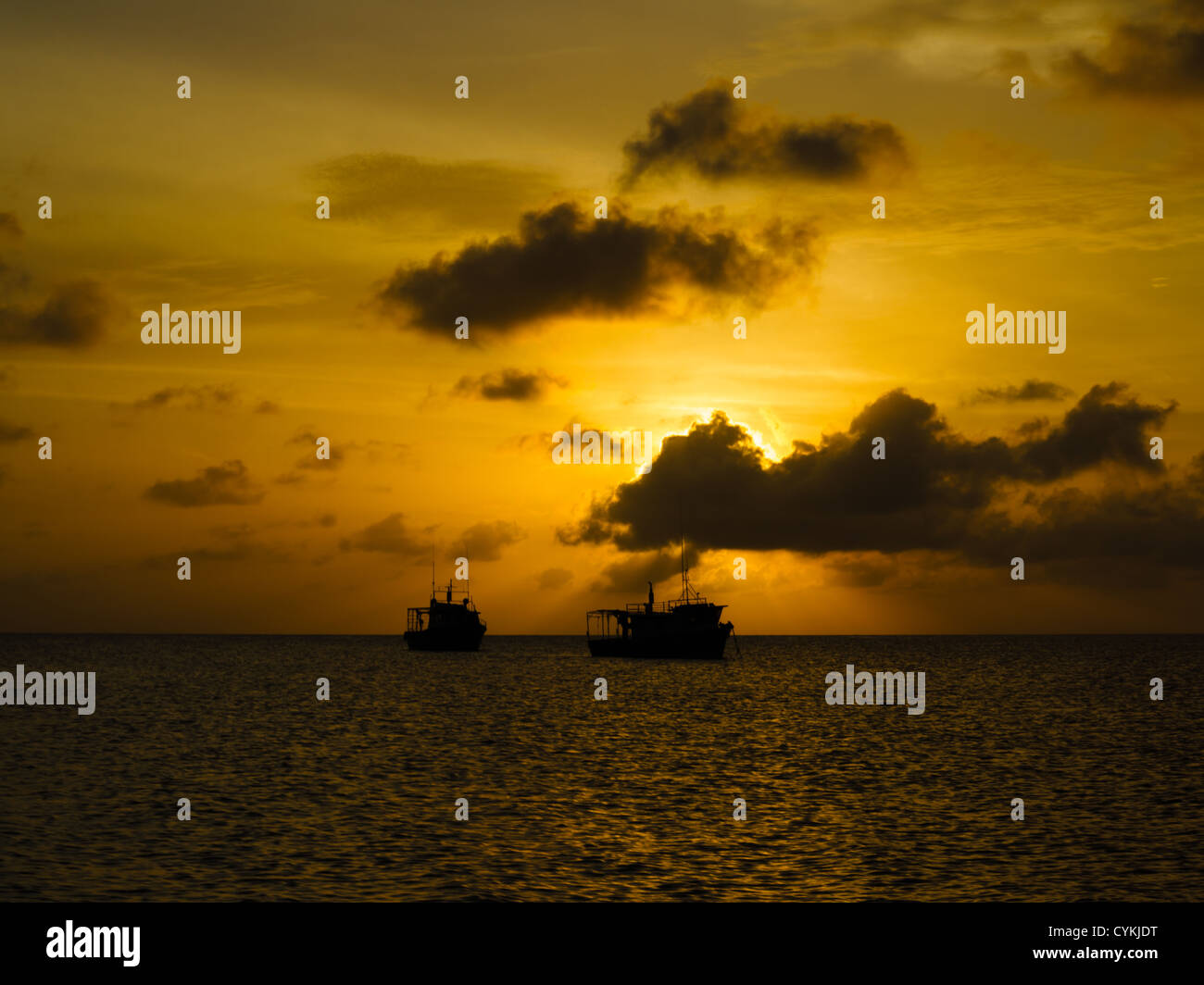 Silhouettes of fishing boats at sunset in Caribbean Stock Photo - Alamy