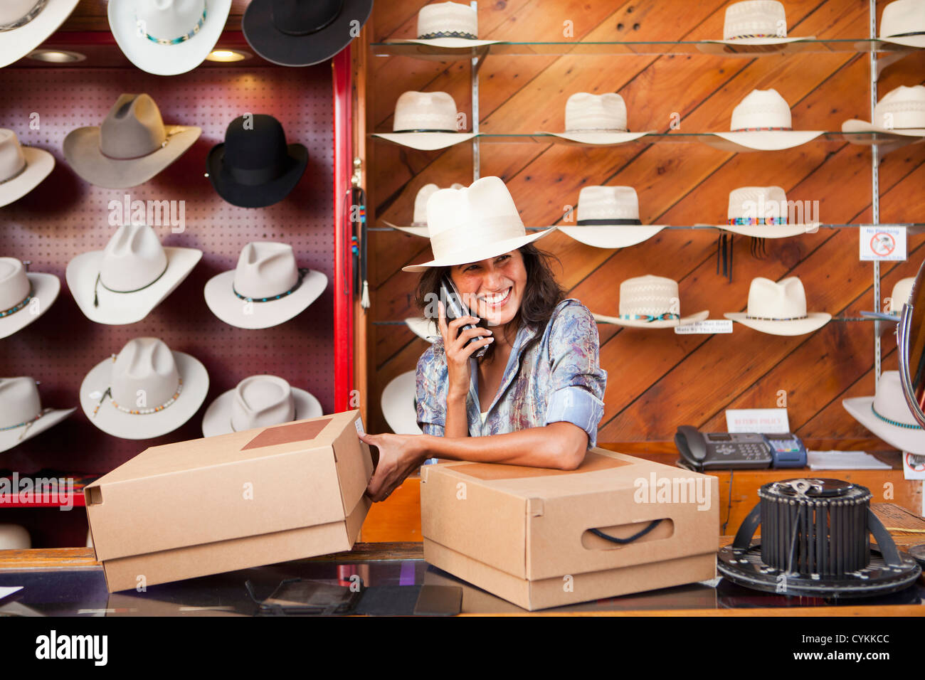 Ecuadorian woman working in hat store Stock Photo