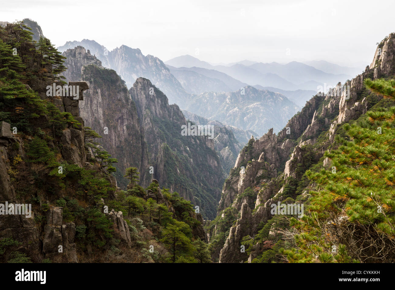 Yellow mountain valley in China during daylight with mountain range and sky in background Stock Photo