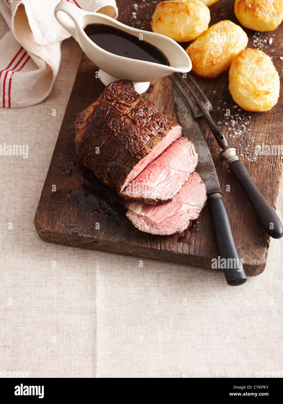 Sliced beef gravy and roast potatoes Stock Photo Alamy