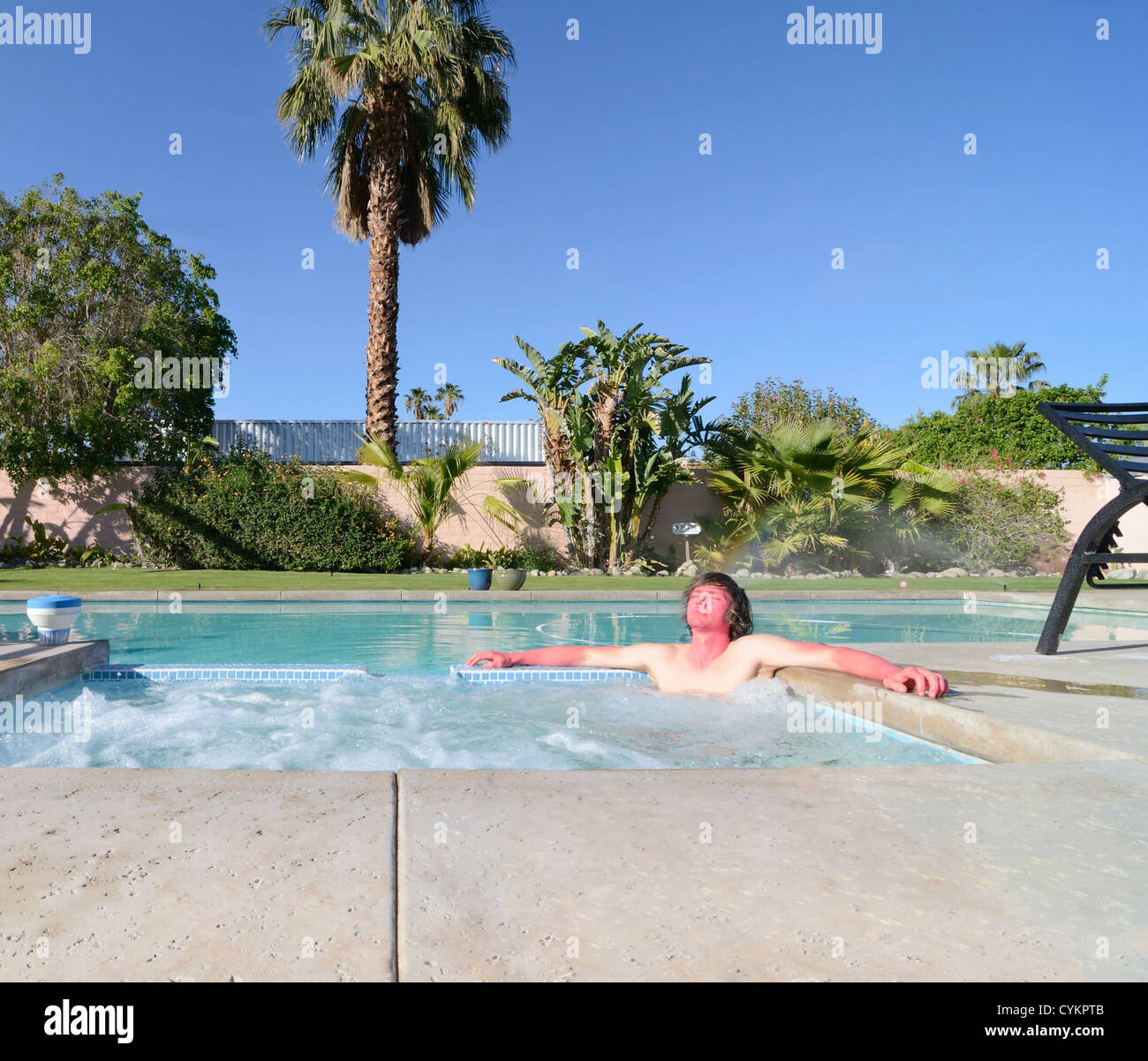 Sunburned man relaxing in hot tub Stock Photo Alamy