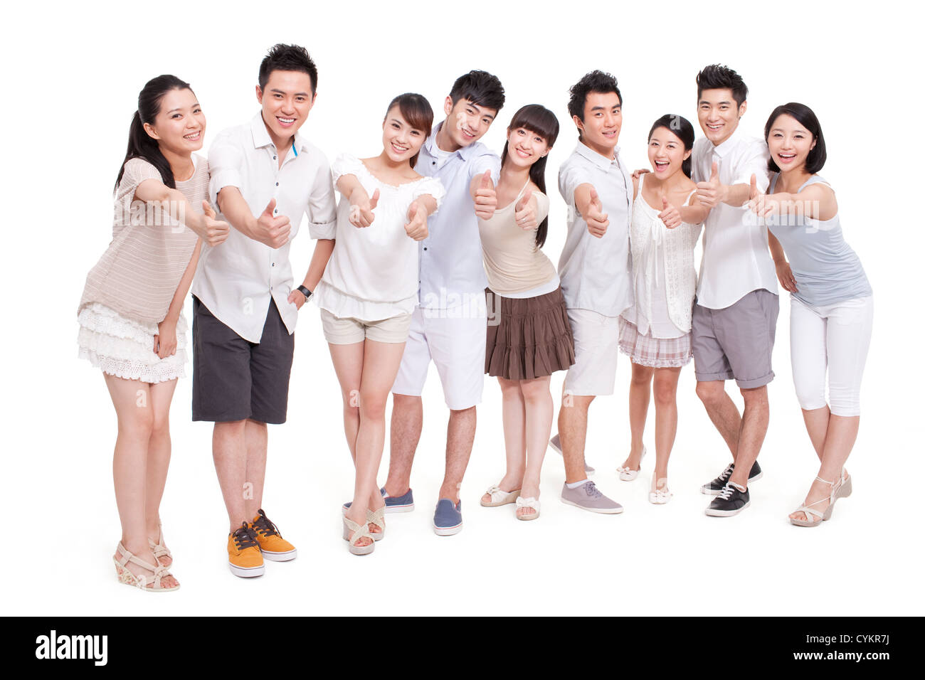 Portrait of young friends showing thumbs up Stock Photo - Alamy