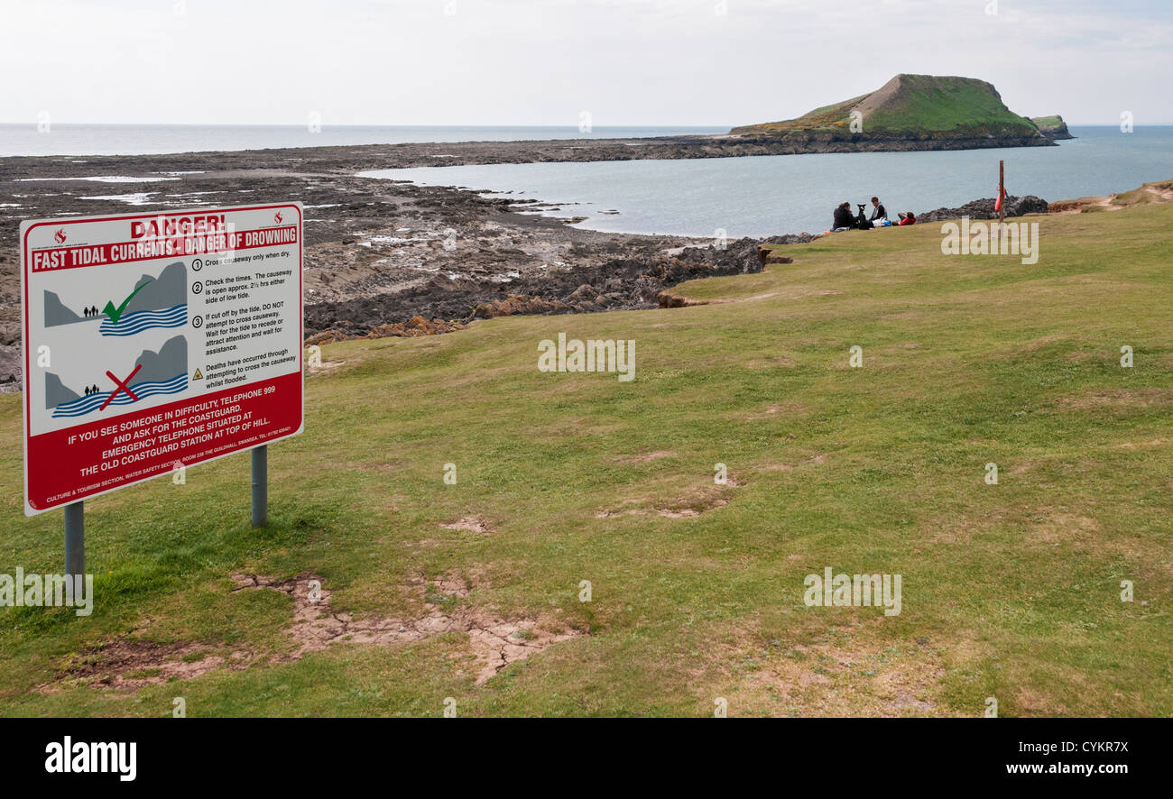 Wales, Gower Peninsula, Rhossili, Worms Head, causeway danger warning sign Stock Photo