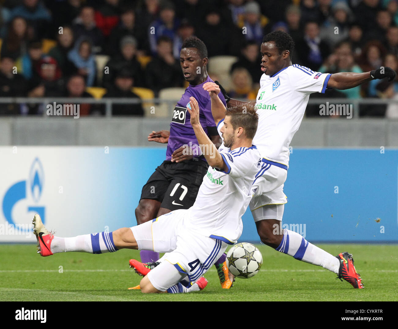 06.11.2012 Silvestre Varela (L) of Porto, Taye Taiwo(R) and Miguel Veloso (C) of Dynamo Kiev during their UEFA Champions League, Group stage (Group A) soccer match of Ukrainian FC Dynamo Kiev vs FC Porto of Portugal on the Olimpiyskiy stadium in Kiev. Stock Photo
