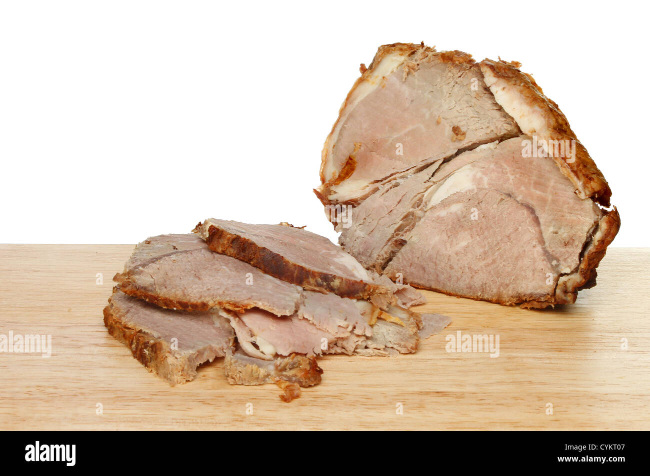Carved cold roast beef joint on a wooden board Stock Photo