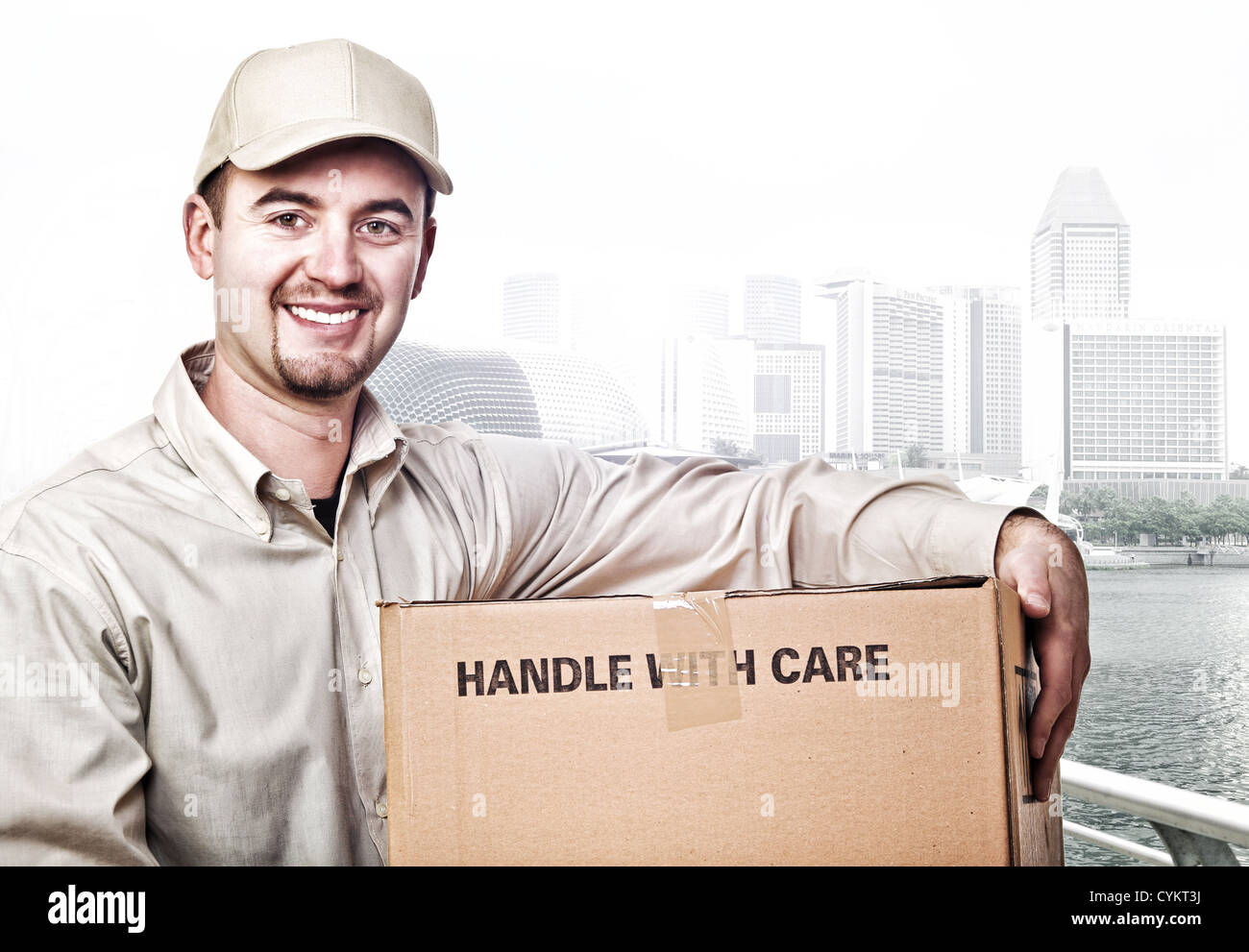 smiling delivery man and modern town background Stock Photo - Alamy