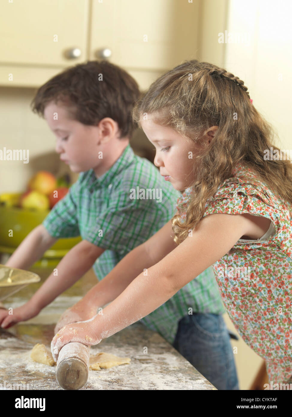 Children baking together in kitchen Stock Photo Alamy
