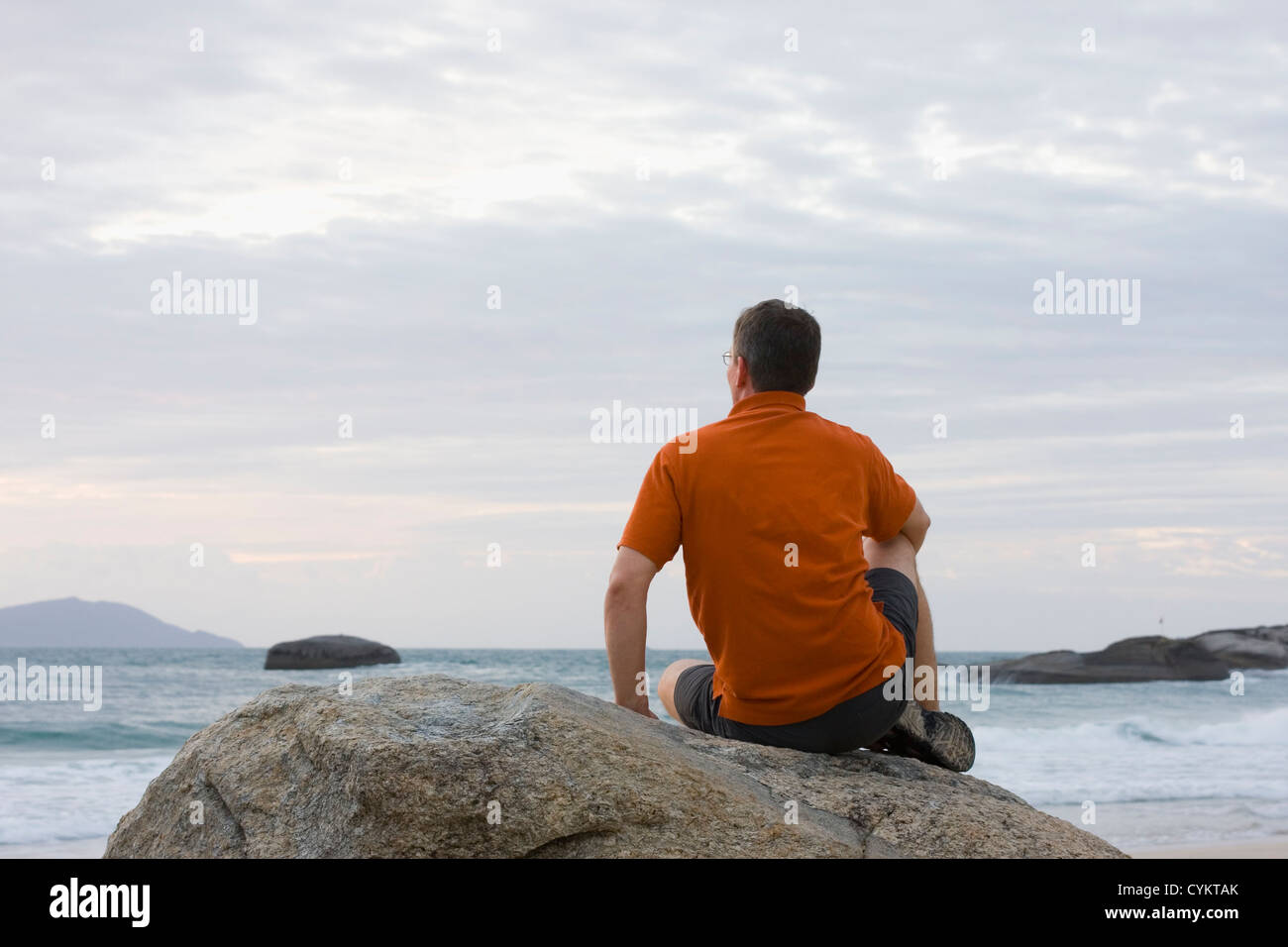 Man is sitting on a rock hi-res stock photography and images - Alamy