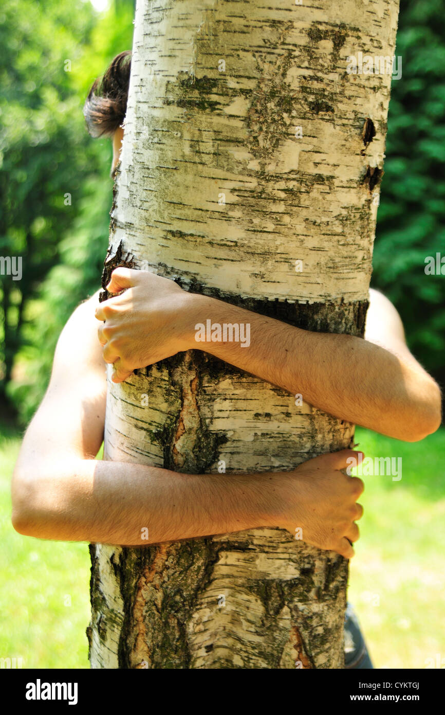 Woman hugging tree in park Stock Photo