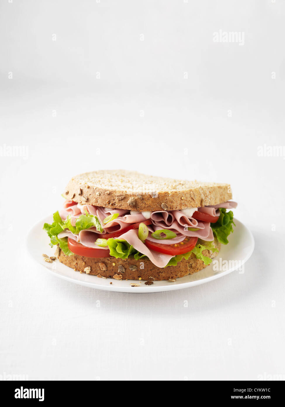 Ham and tomato sandwich on plate Stock Photo