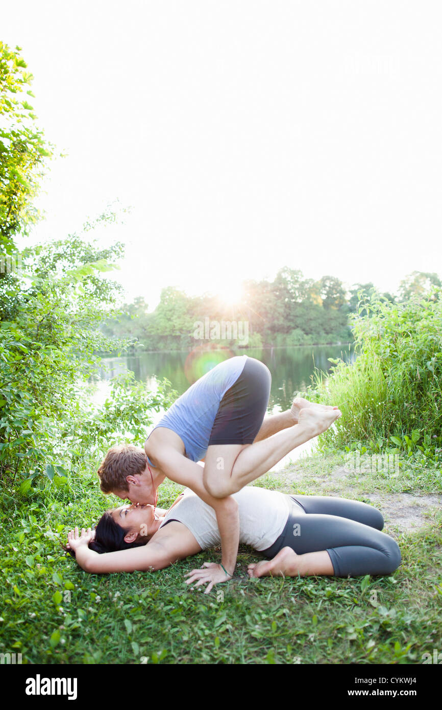 Couple kissing and practicing yoga Stock Photo