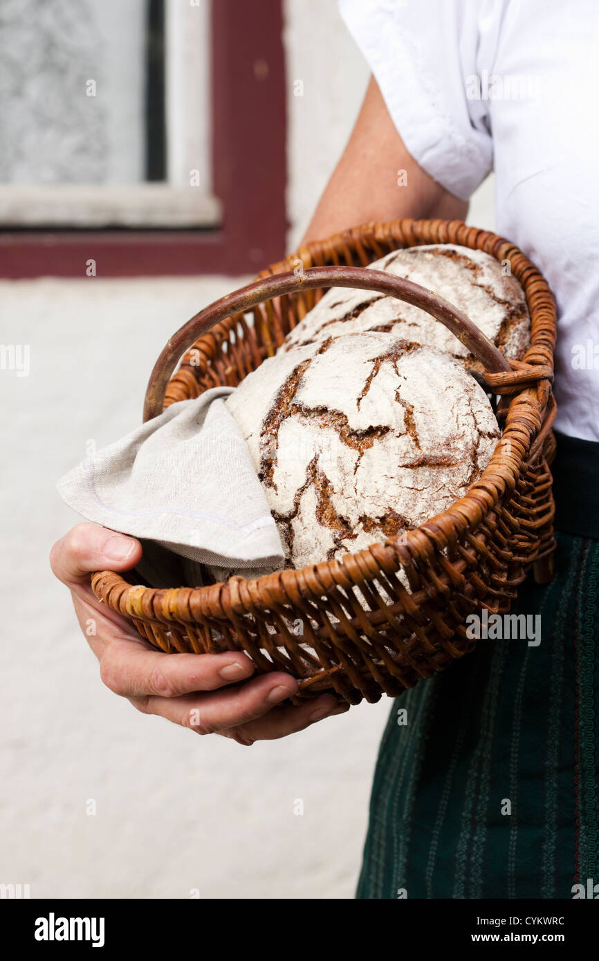 Man holding basket of sourdough bread Stock Photo