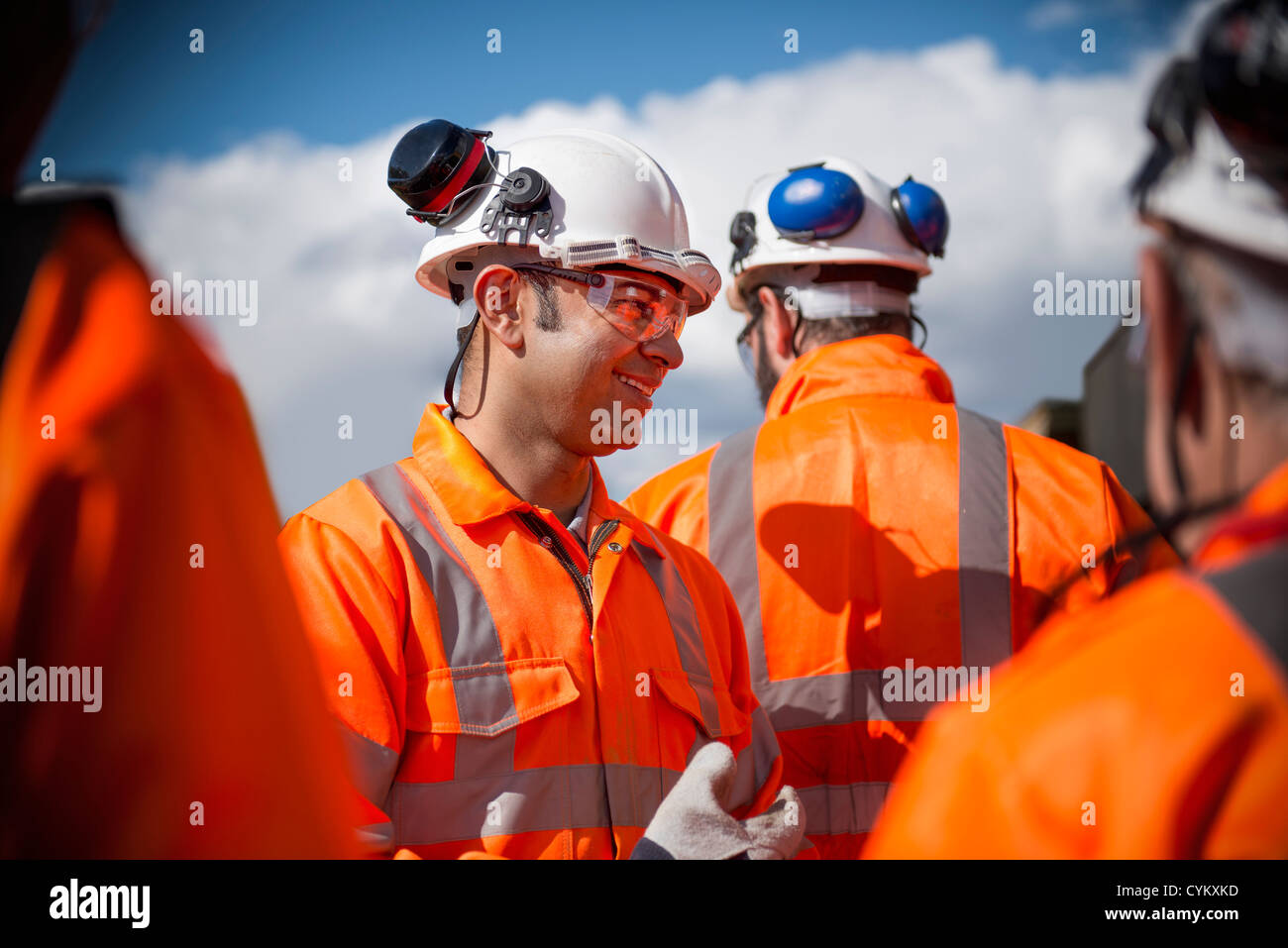 Railway workers talking outdoors Stock Photo