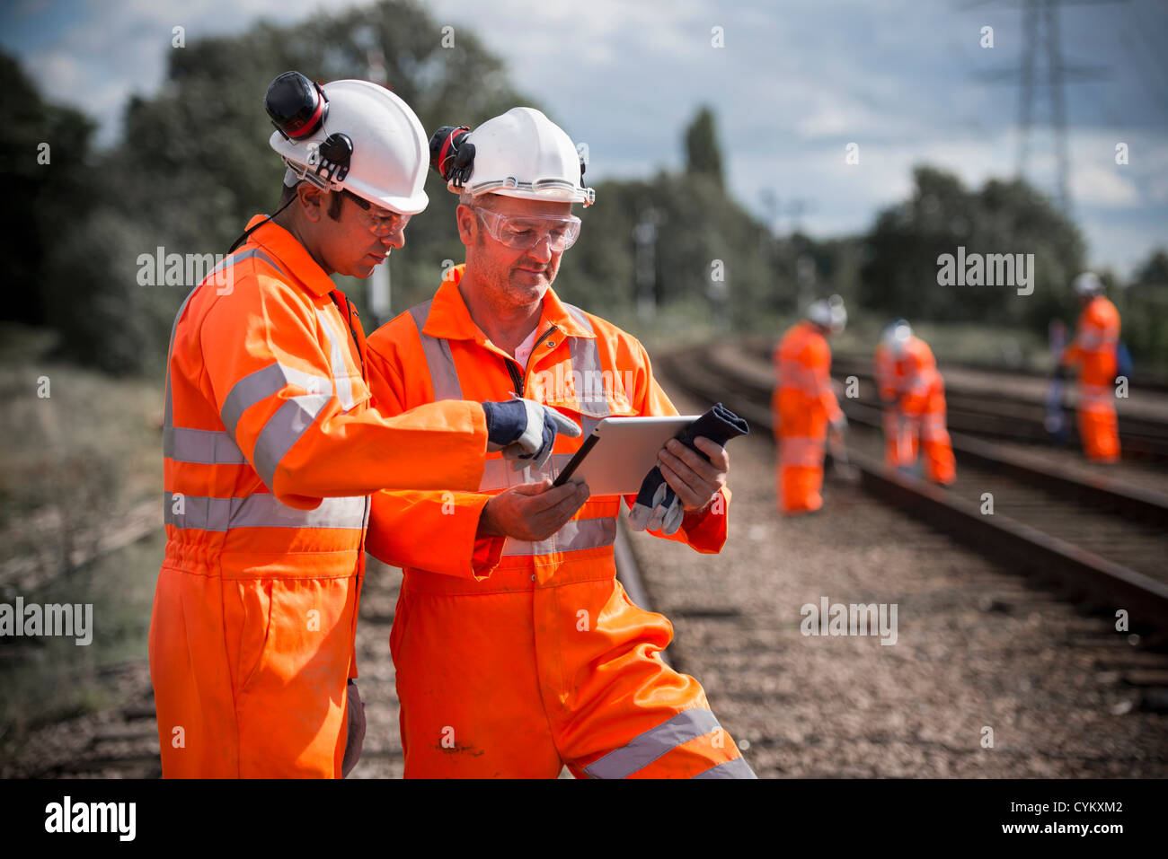Railway workers using tablet computer Stock Photo