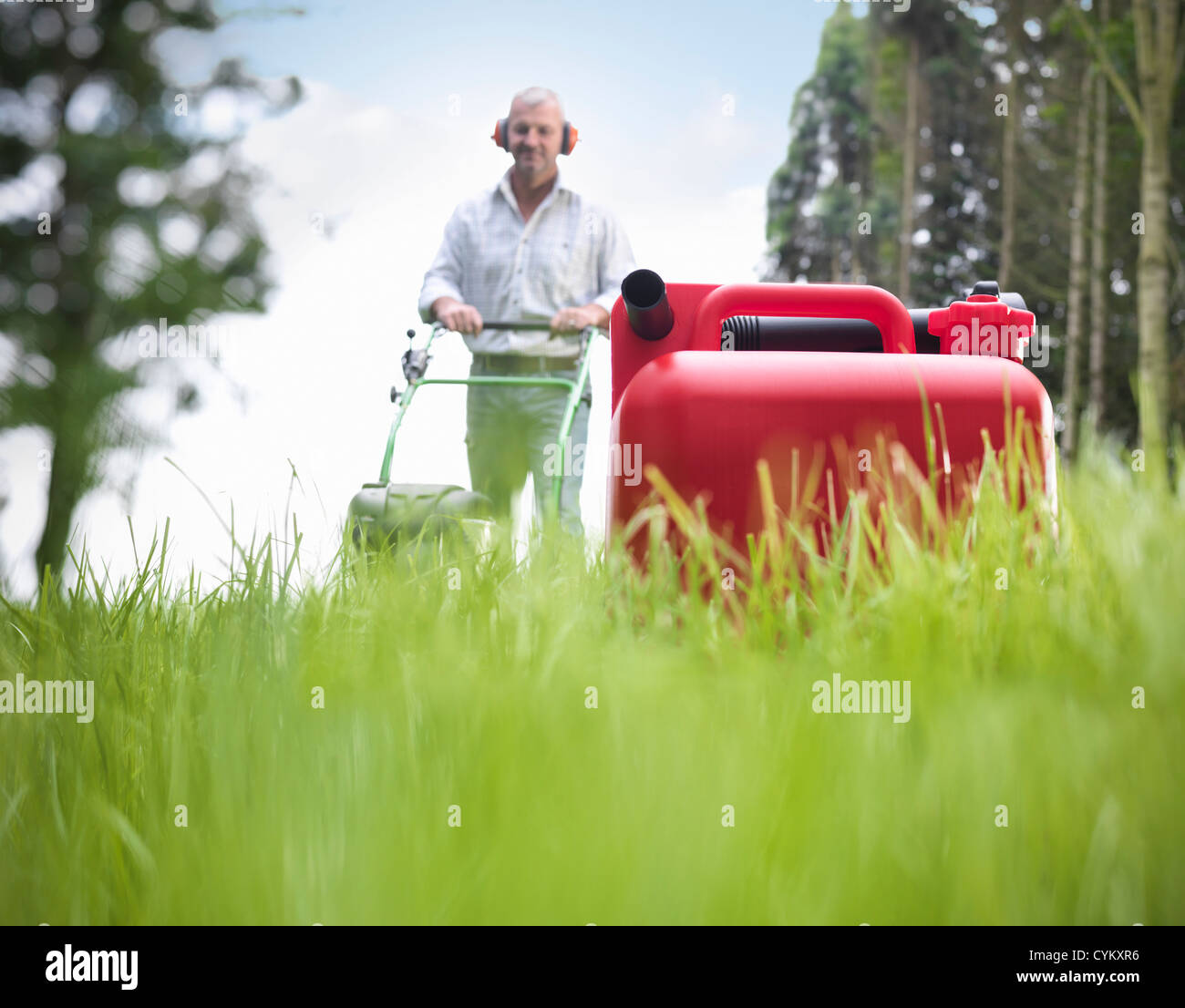 Can of gasoline on grassy lawn Stock Photo