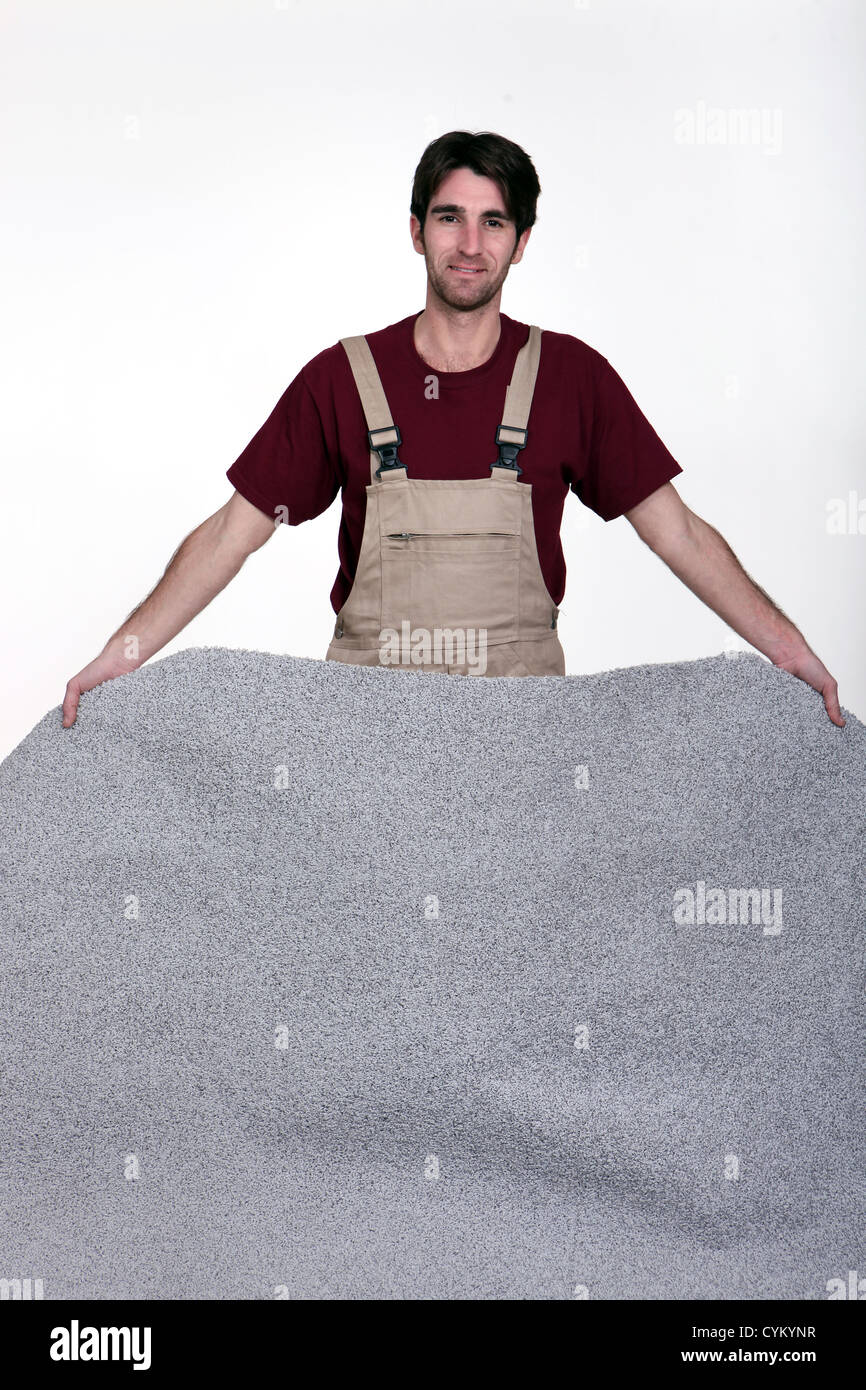 Man laying new carpet Stock Photo Alamy