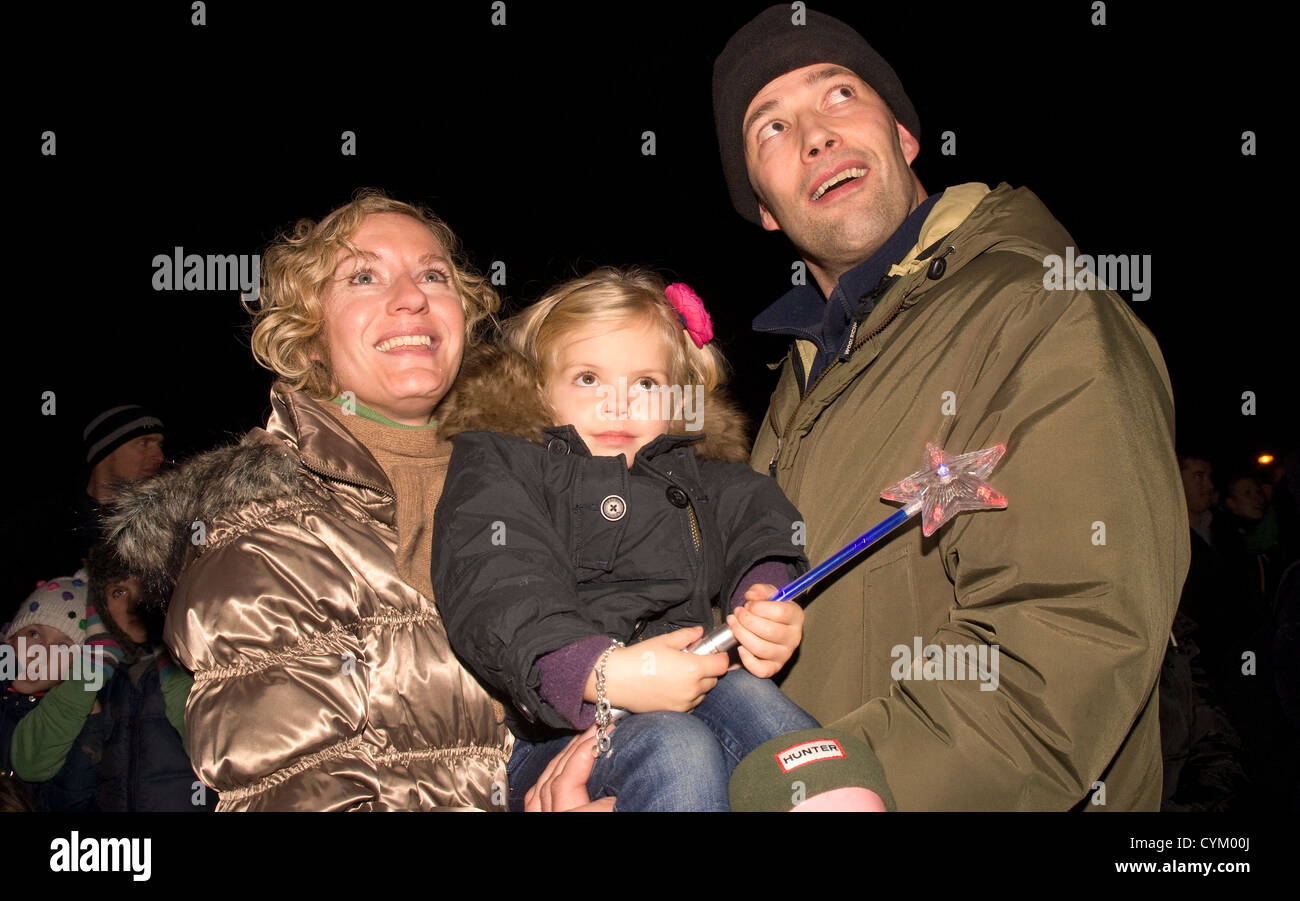 Family watching the fireworks on bonfire night, Chiddingfold, Surrey, UK. November 2012. Stock Photo