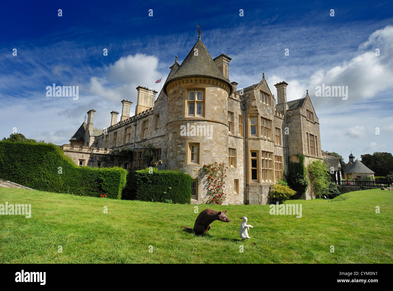 A duck and a fox in the foreground of Beaulieu Palace House Stock Photo
