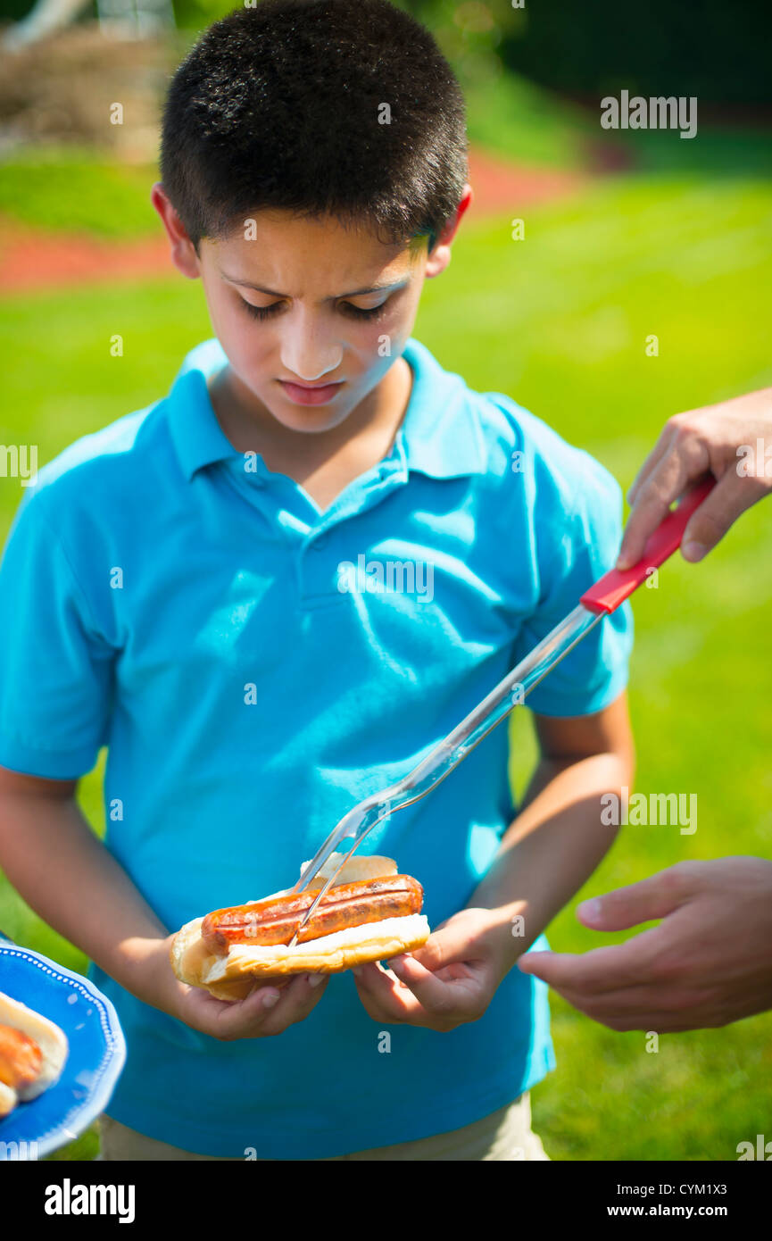 Man serving son hot dog outdoors Stock Photo Alamy