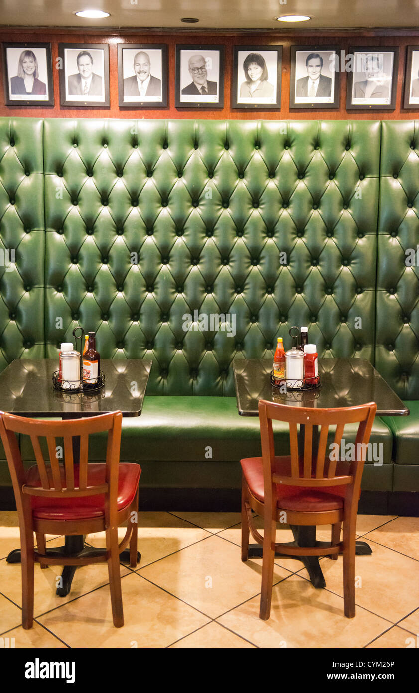 Drawings of celebrities above upholstered seating at Ronny's Streakhouse, a Chicago institution serving value meals. Stock Photo