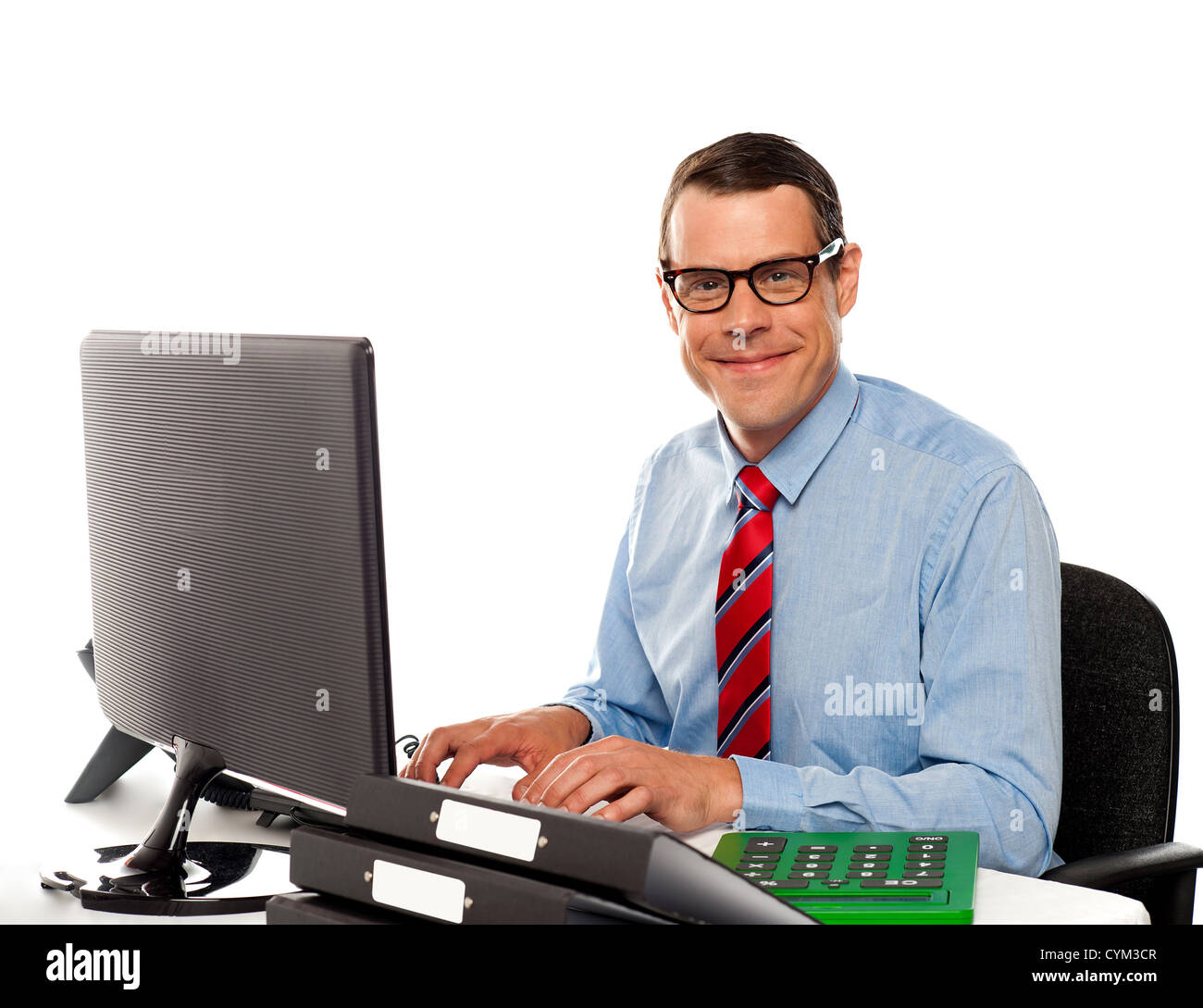 Happy young corporate man using computer against white background Stock ...