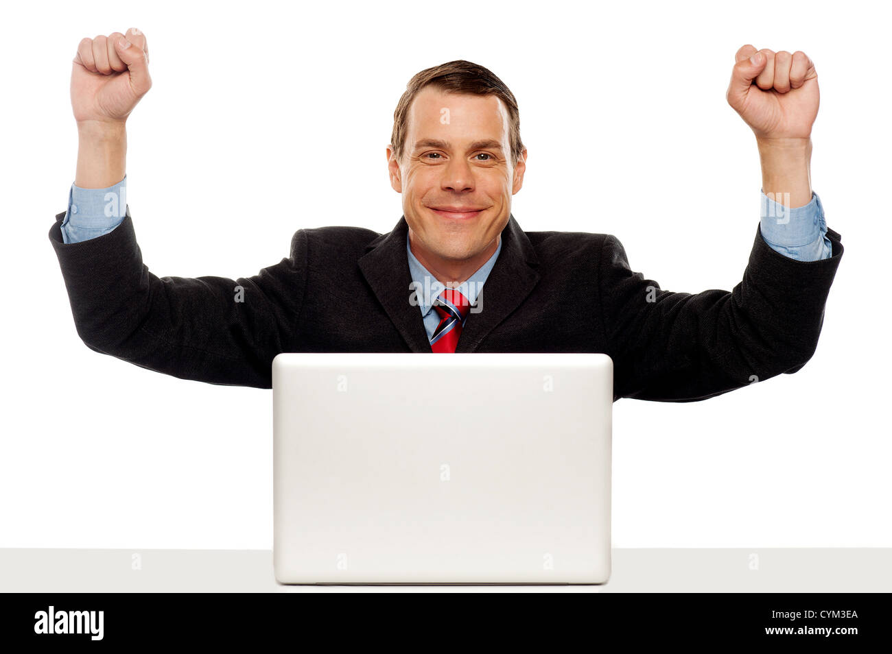 Excited businessman celebrating success with his arms raised up ...