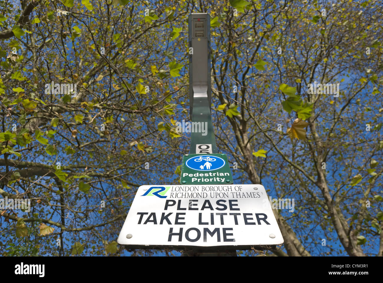 please take litter home sign, below sign indicating cyclist and pedestrian shared path, twickenham, middlesex, england Stock Photo