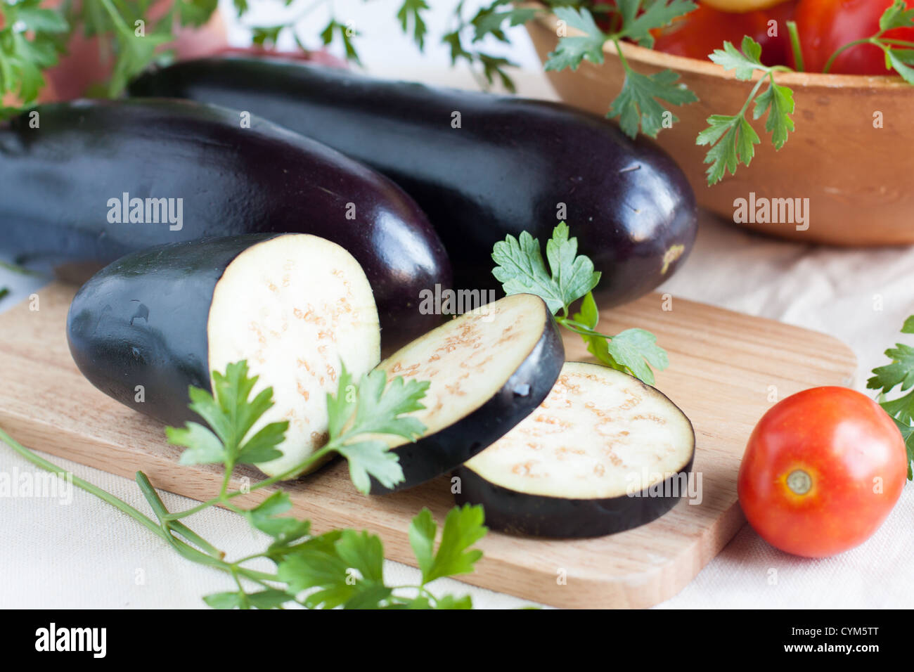 Raw eggplant lie on the cutting board, close up Stock Photo