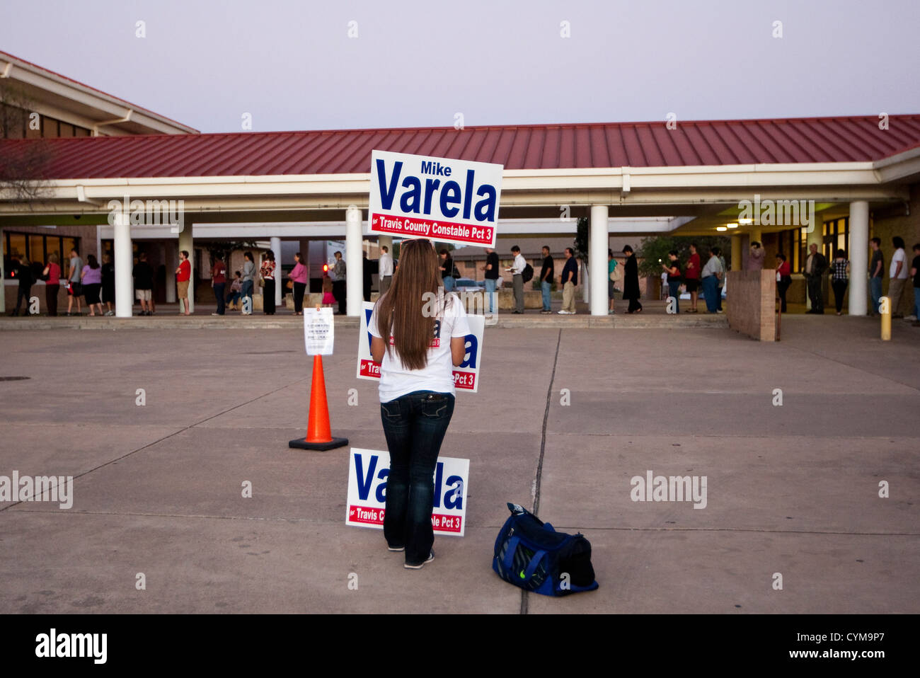 November 6th, 2012 Austin, Texas: Volunteer holds campaign sign just beyond the distance marker at a voting location in Travis Stock Photo