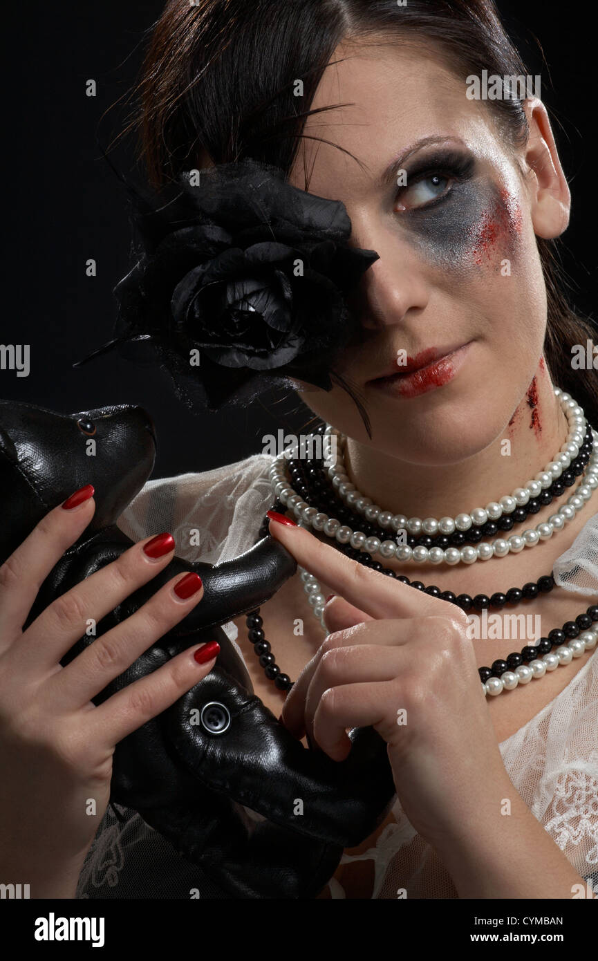Gothic girl holding black rose hi-res stock photography and images - Alamy