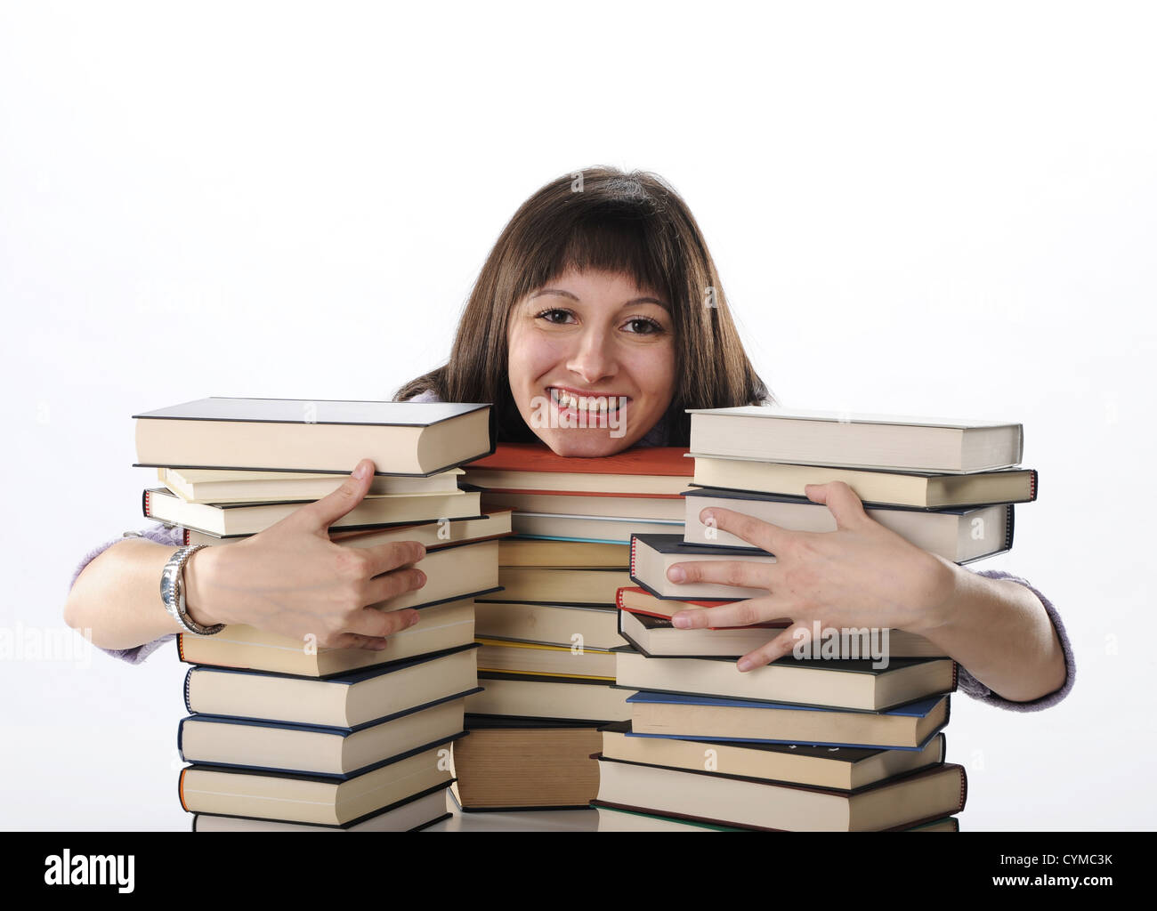 Using Books young woman behind a big pile of books Stock Photo - Alamy