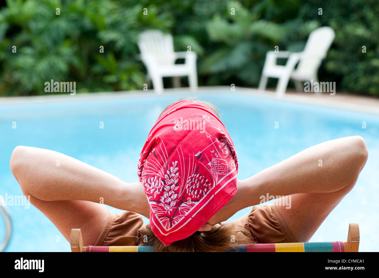 woman relaxing by swimming pool Stock Photo