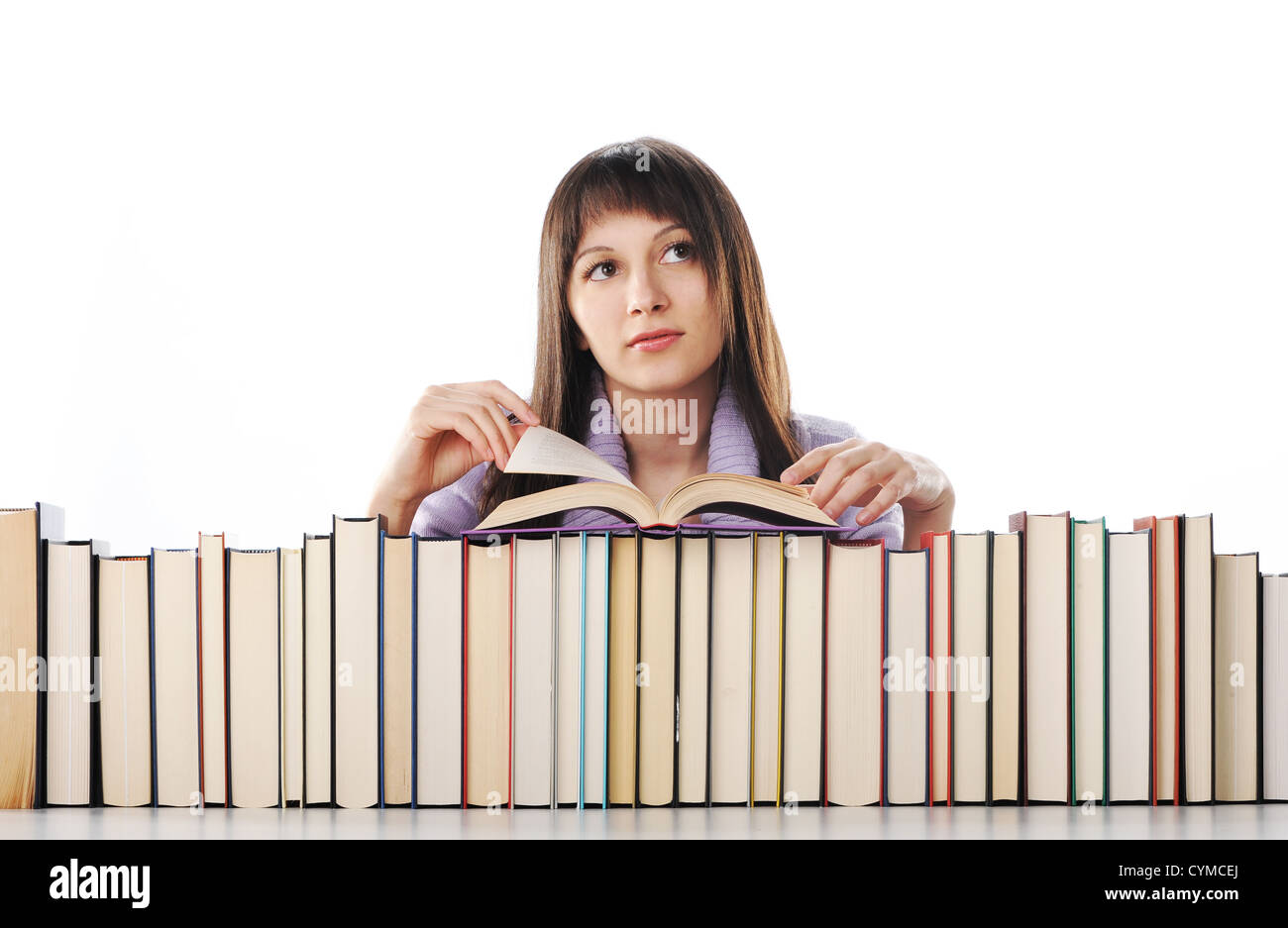 young woman behind a big pile of books Stock Photo - Alamy