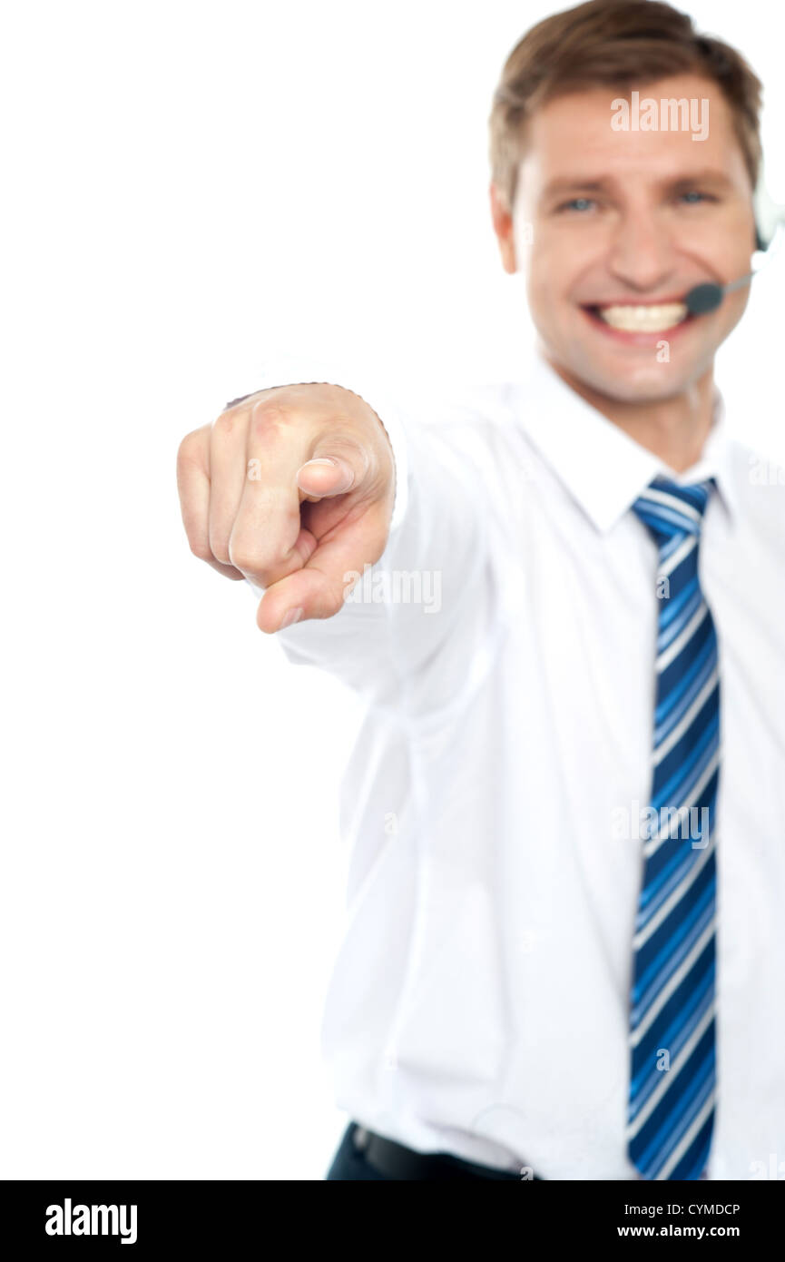 Cheerful male executive pointing at you isolated over white background ...