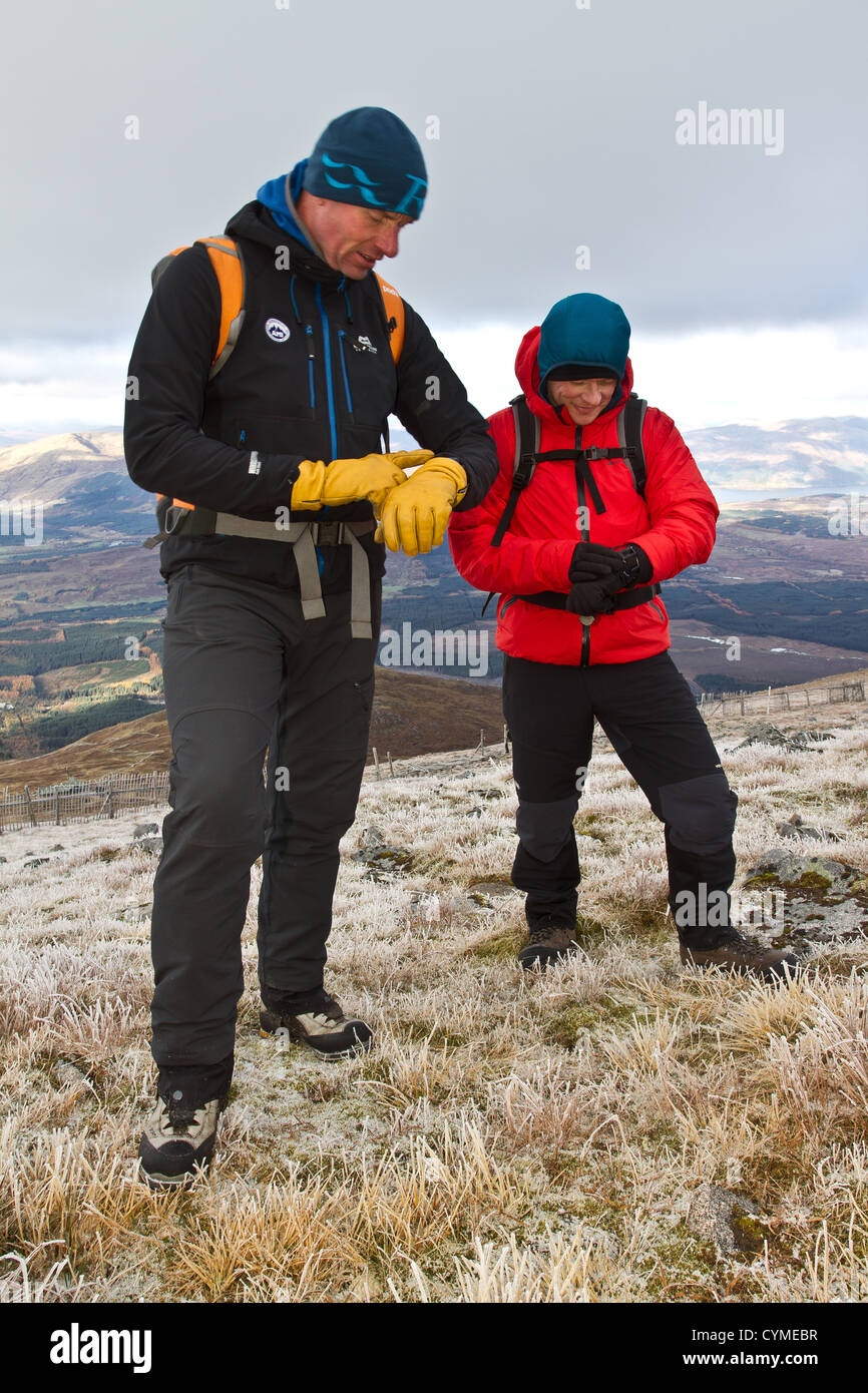 A man using a wrist watch GPS navigation system in the Scottish Mountains Stock Photo