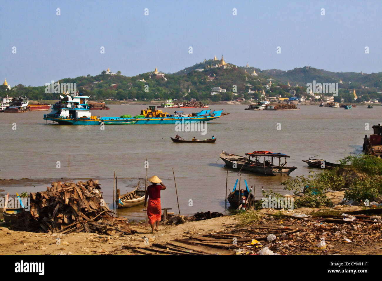 Boat traffic on the IRRAWADDY RIVER with SAIGAING HILL behind - MANDALAY, MYANMAR Stock Photo