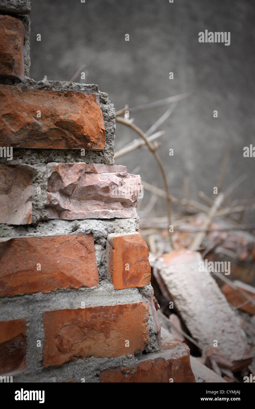 Bricks and mortar with broken walls Stock Photo