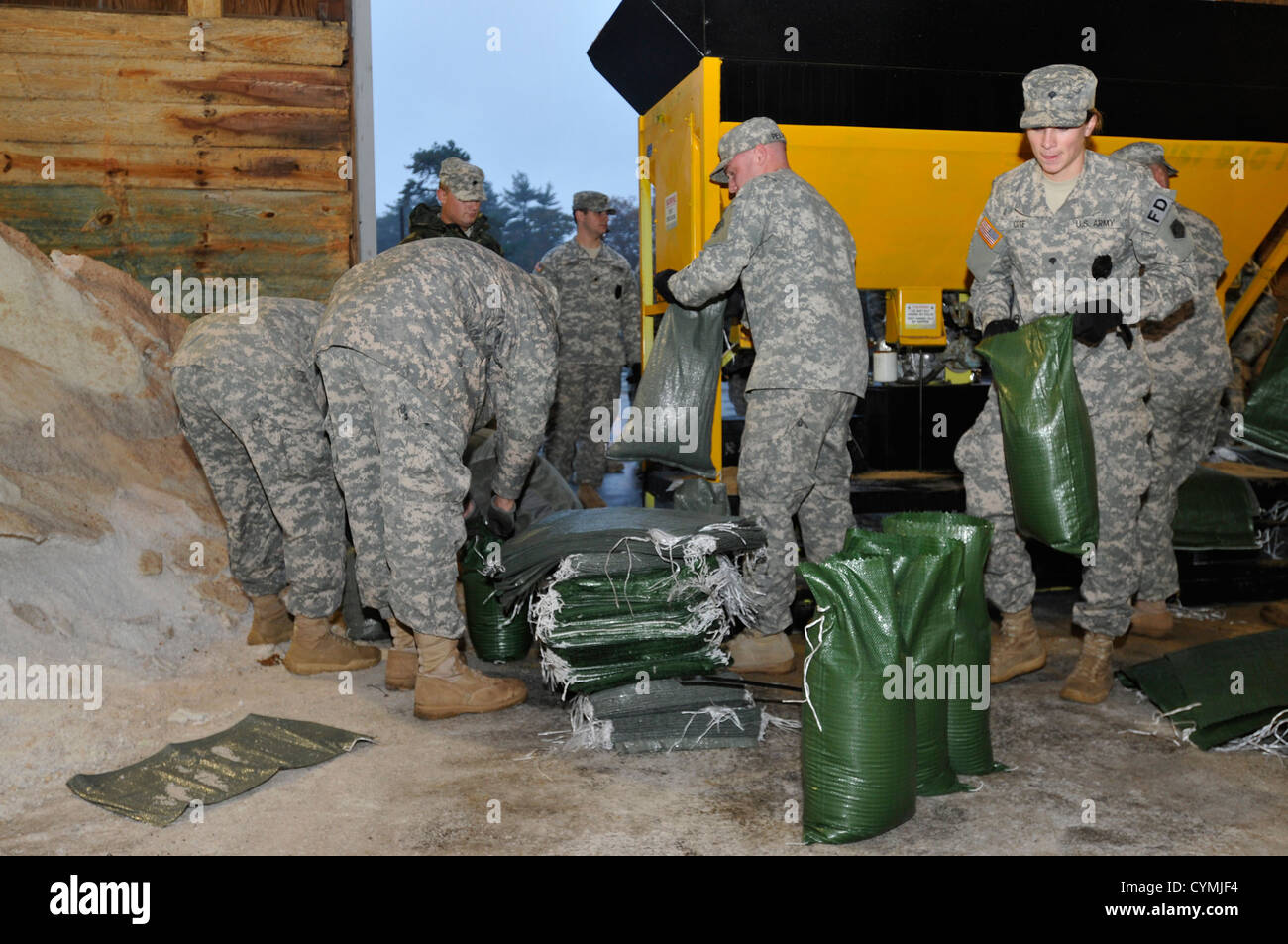Massachusetts National Guardsmen fill sand bags Oct. 28, 2012, in preparation for Hurricane Sandy at the Massachusetts Department of Transportation facility. (Photo by Staff Sgt. James Lally) Stock Photo
