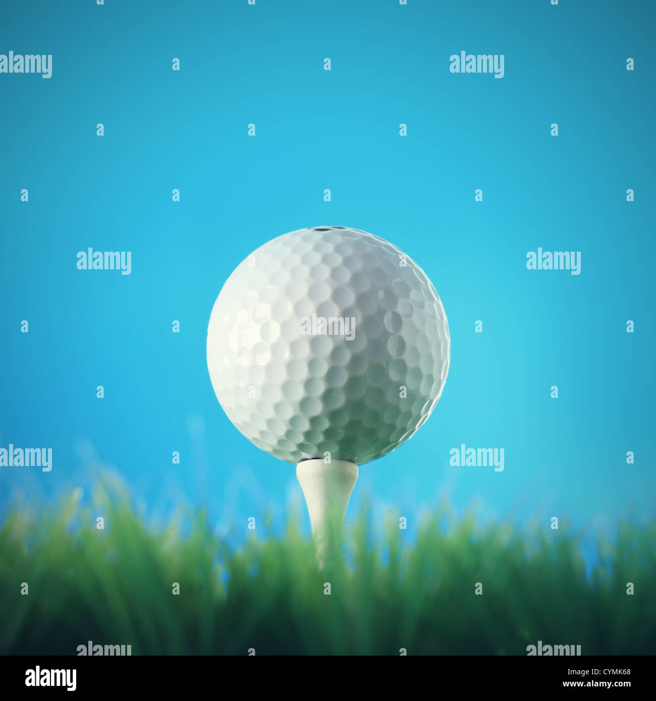 Golf ball in the grass against a blue sky Stock Photo - Alamy