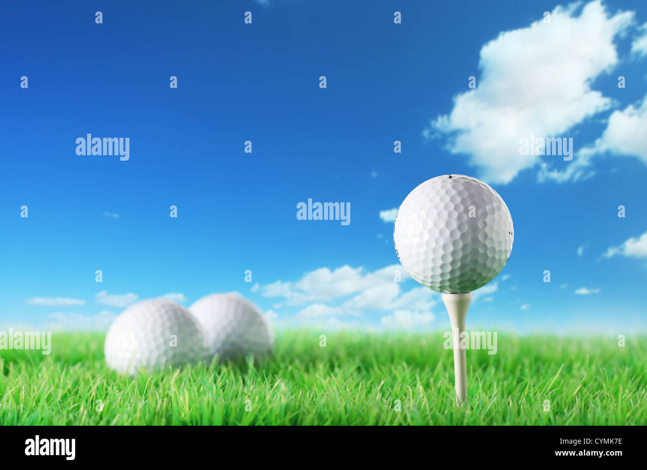 Golf ball in the grass against a blue sky Stock Photo - Alamy
