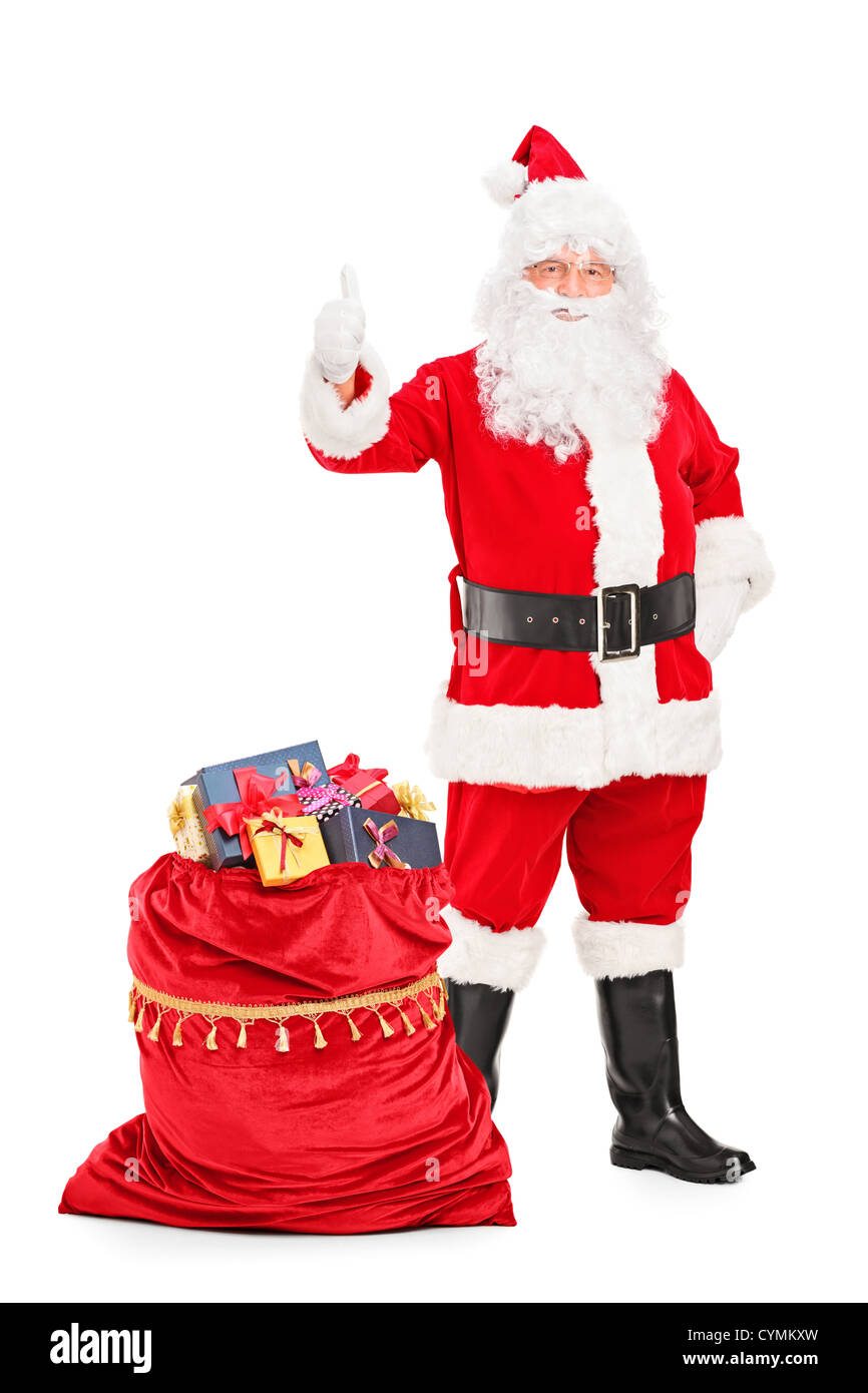 Full length portrait of a Santa Claus with a bag full of gifts giving a ...