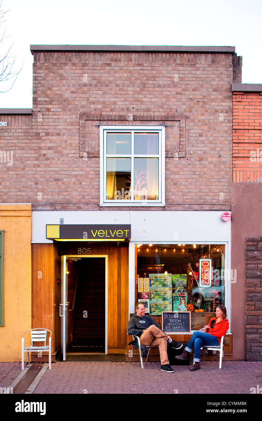 A man and a woman sit outside a cafe enjoying the good weather in Bend, Oregon. Stock Photo