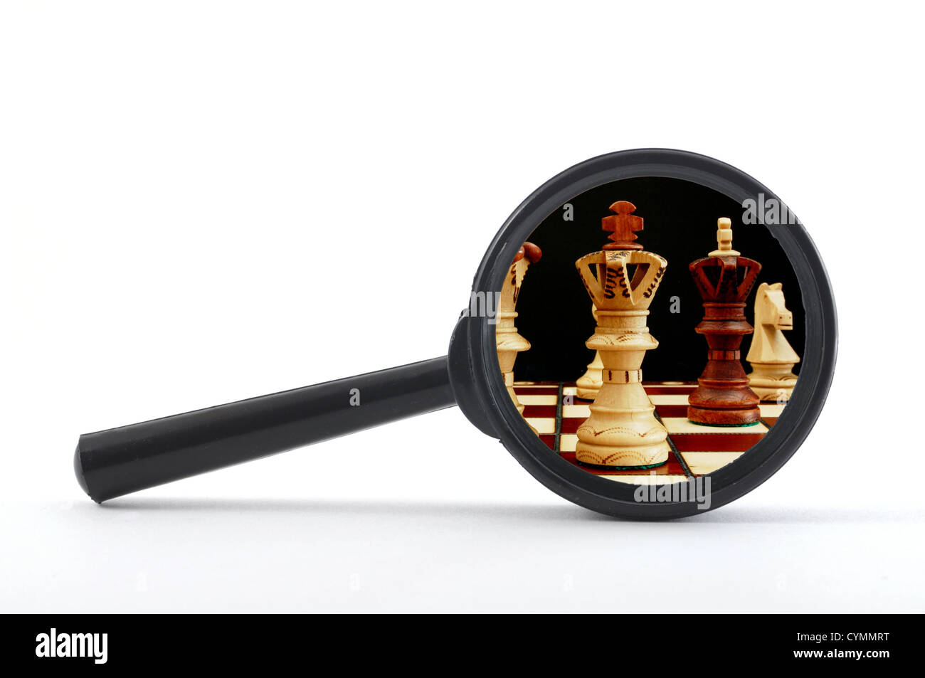 business competition concept with chess pieces and magnifying glass Stock Photo