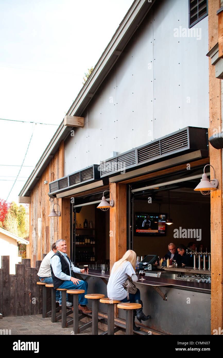 Patrons sit at an outdoor bar at one of the many breweries in Bend