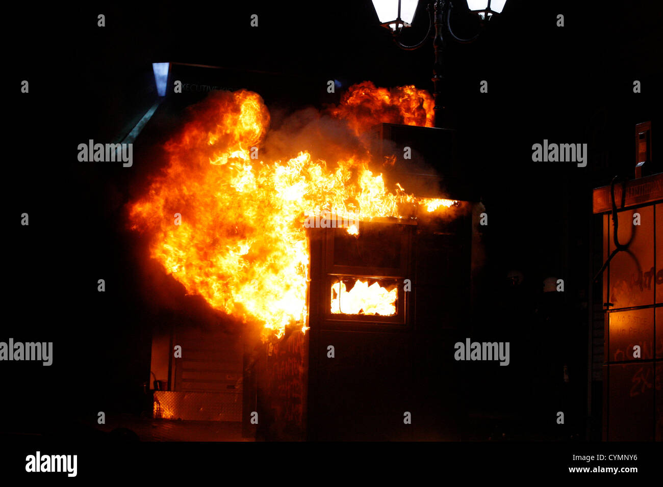 Nov. 7, 2012 - Athens, Greece - A bus ticket kiosk is burning near the ...