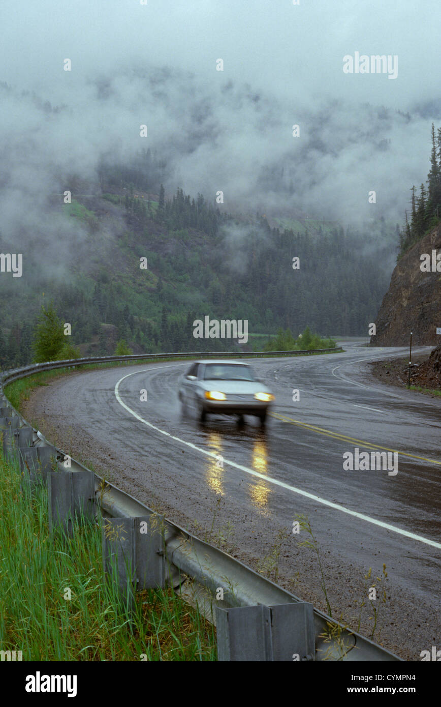 Passenger automobile traveling in dangerous rain and fog driving